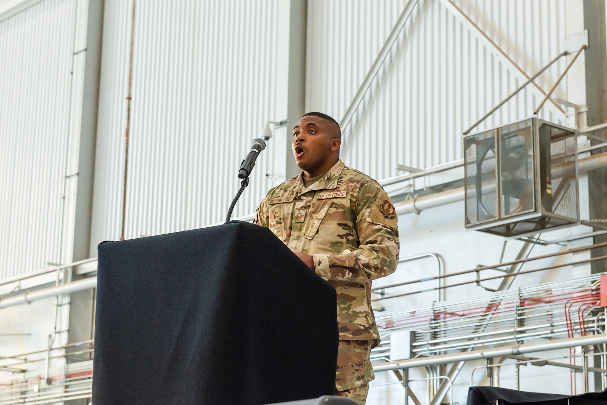 Master Sgt. Marshall Merriweather, 412th Logistics Readiness Squadron, sings the National Anthem during the 75th Anniversary of Supersonic Flight Ceremony Oct. 14.