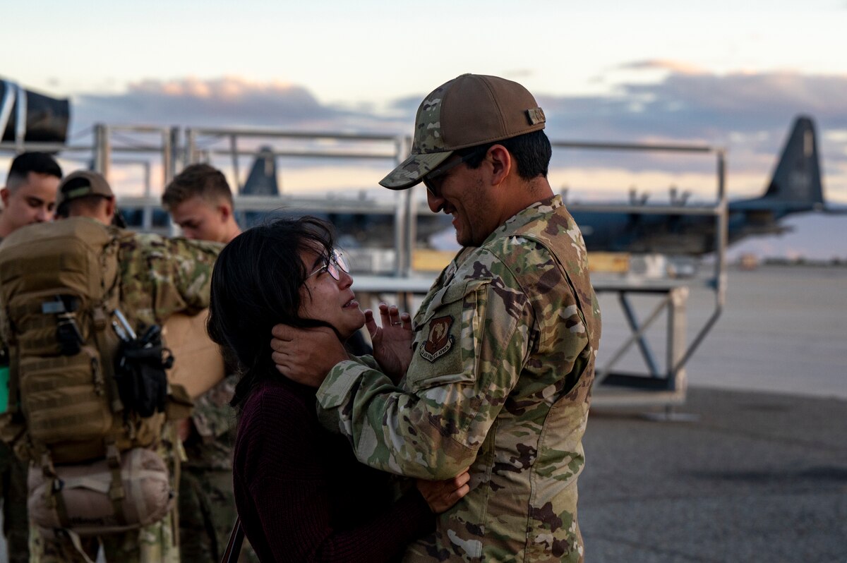 A photo of a family member greeting a loved one that came home from deployment
