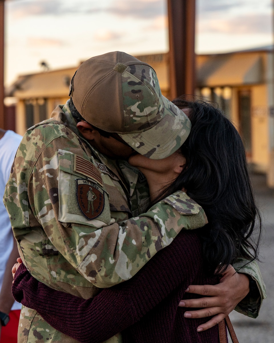 A photo of a family member greeting a loved one that came home from deployment