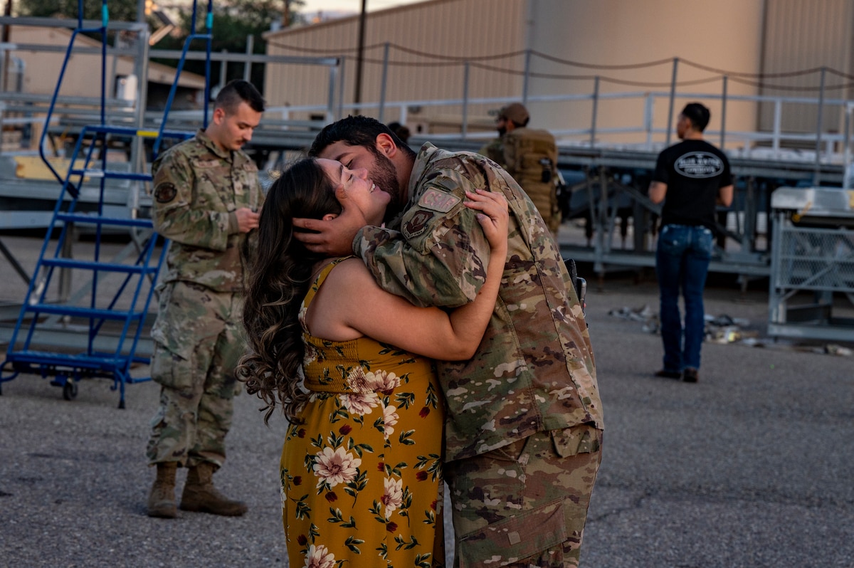 A photo of a family member greeting a loved one that came home from deployment