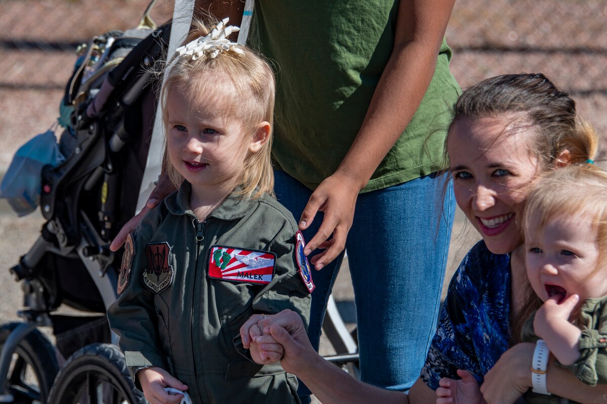 A photo of a family member greeting a loved one that came home from deployment
