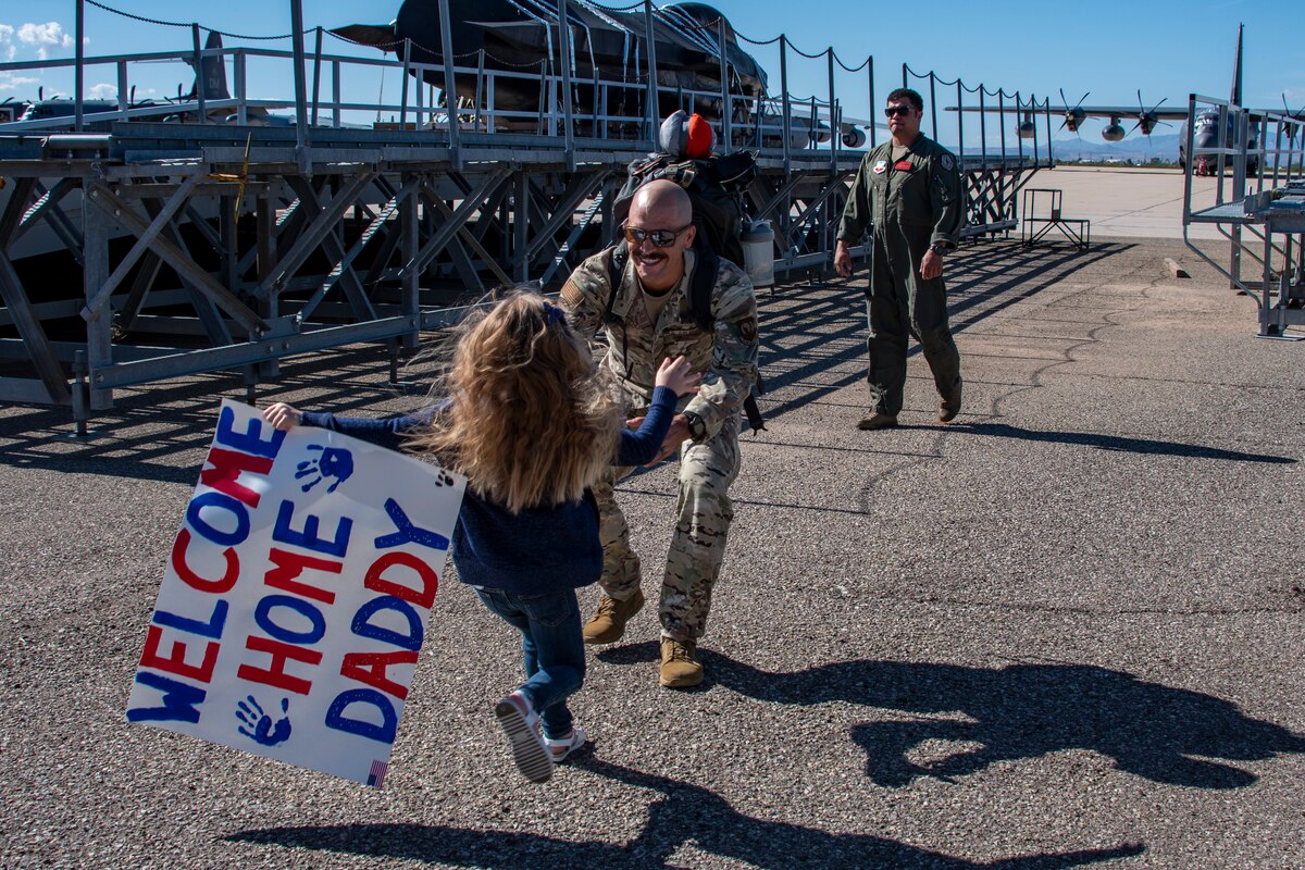 A photo of a family member greeting a loved one that came home from deployment