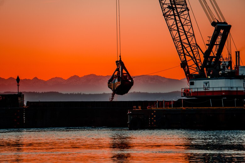 A commercial vessel is lowering a dredging claw to remove sediment in Everett Harbor along the Snohomish River.