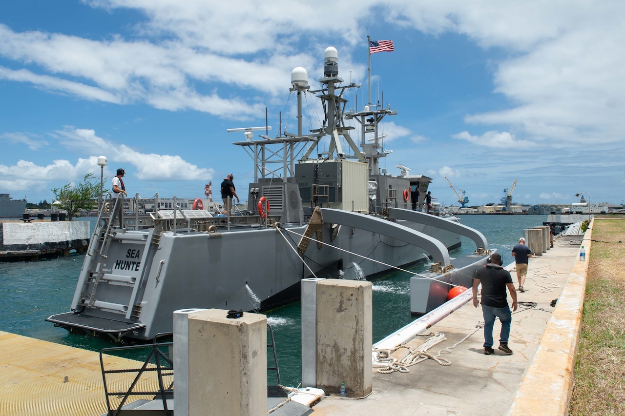 Two lines stretch from a dock to a vessel.