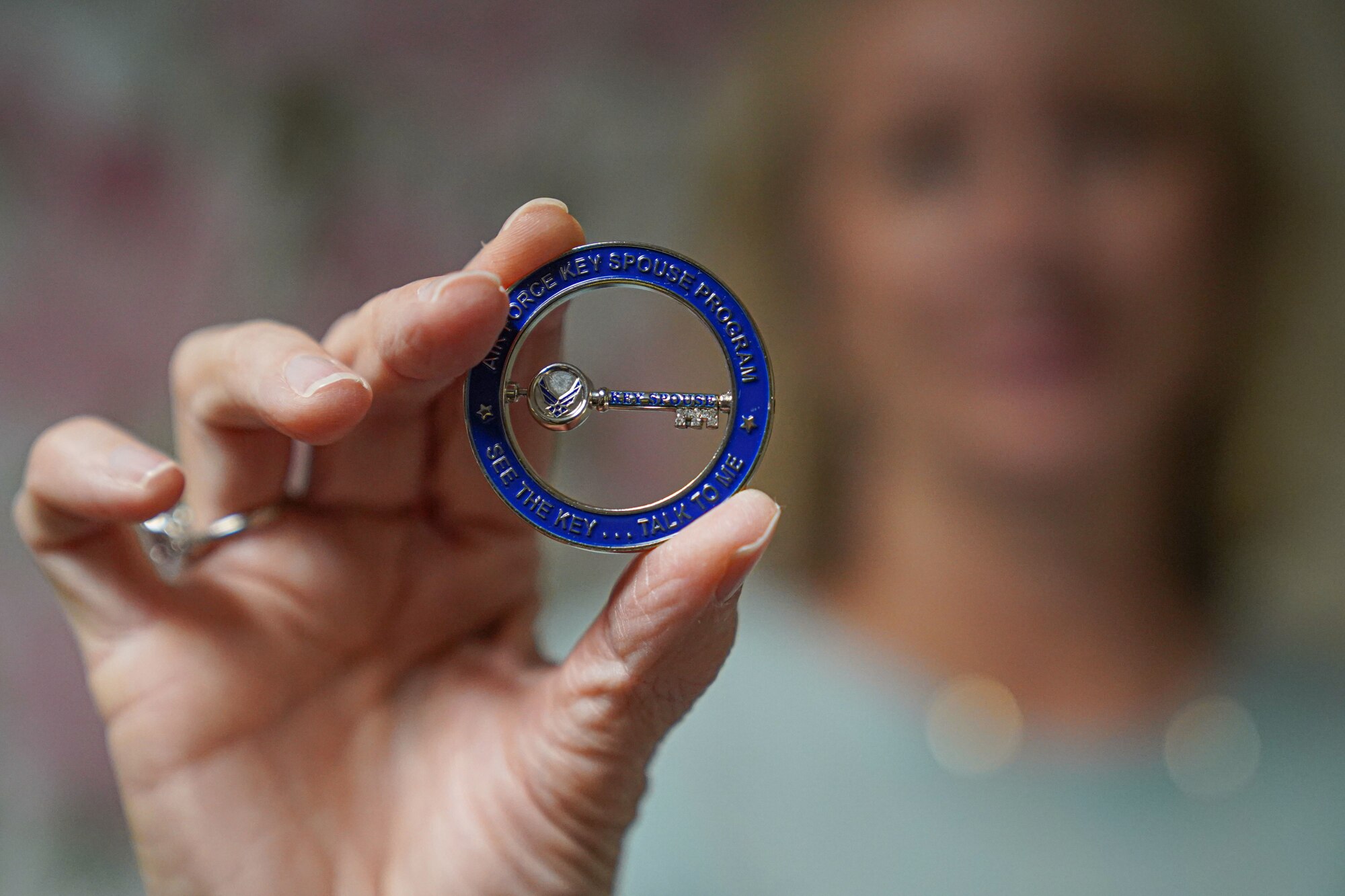 Rhonda Ferrell, 81st Force Support Squadron key spouse coordinator, displays a Key Spouse coin in the Sablich Center on Keesler Air Force Base, Mississippi, Oct. 17, 2022.