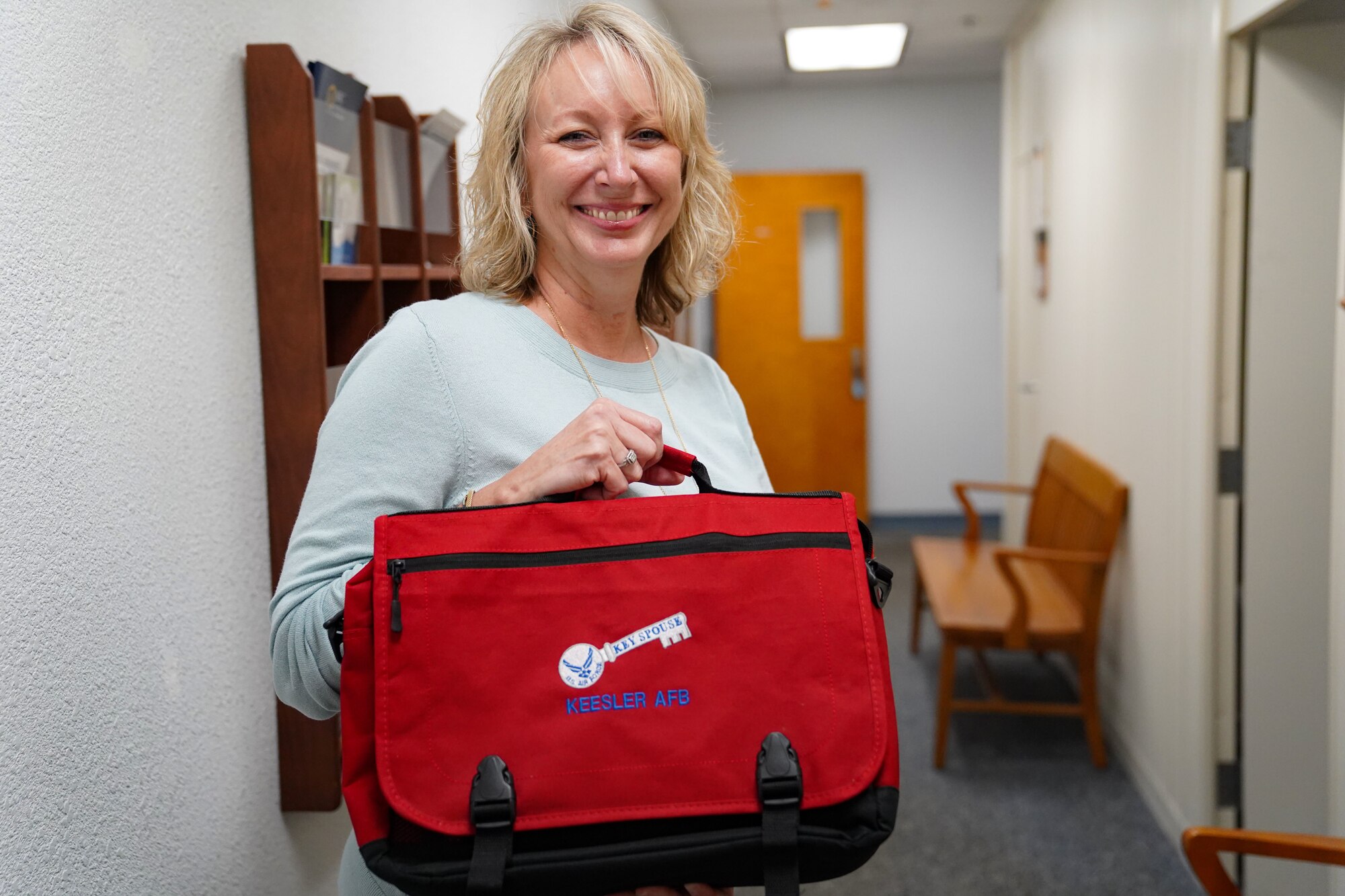 Rhonda Ferrell, 81st Force Support Squadron key spouse coordinator, displays a Key Spouse bag in the Sablich Center on Keesler Air Force Base, Mississippi, Oct. 17, 2022.