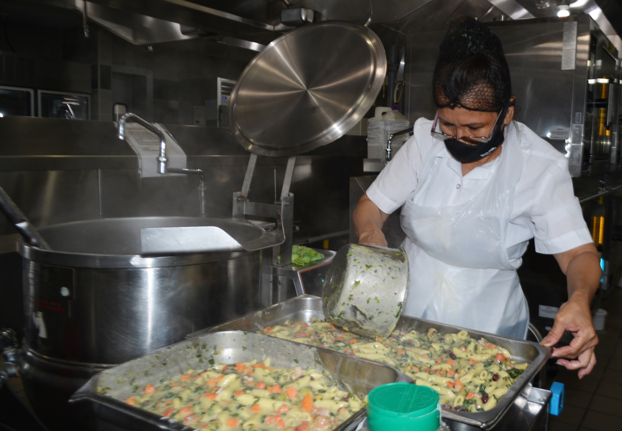 Anita Sparks, Freedom Hall Dining Facility cook, readies pasta provencal for a lunch time meal at the dining facility at Joint Base Andrews, Md., Oct. 4, 2022.