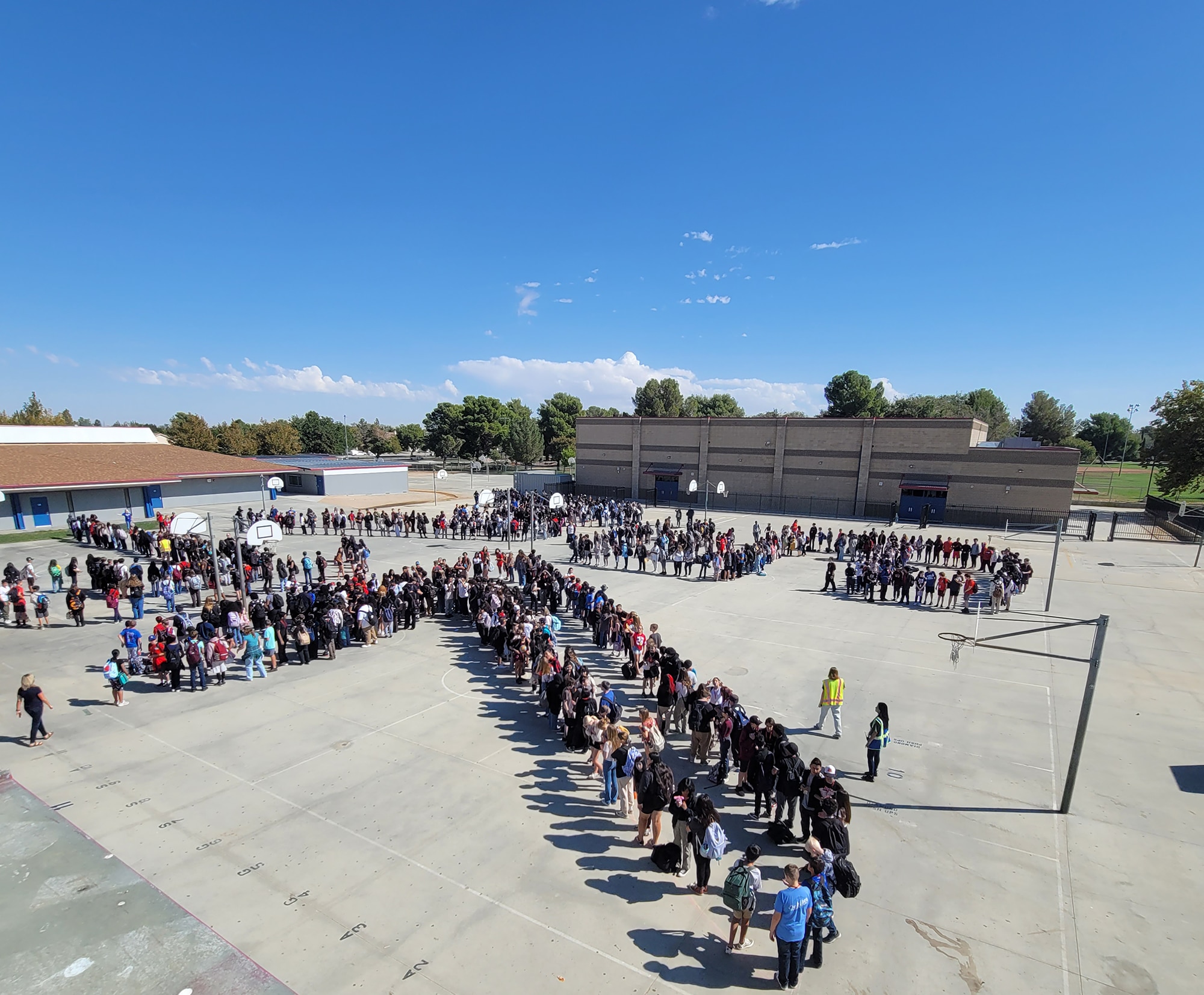 Hundreds of kids at Joe Walker Middle School create a "JW 75" formation to celebrate the STEM flyover