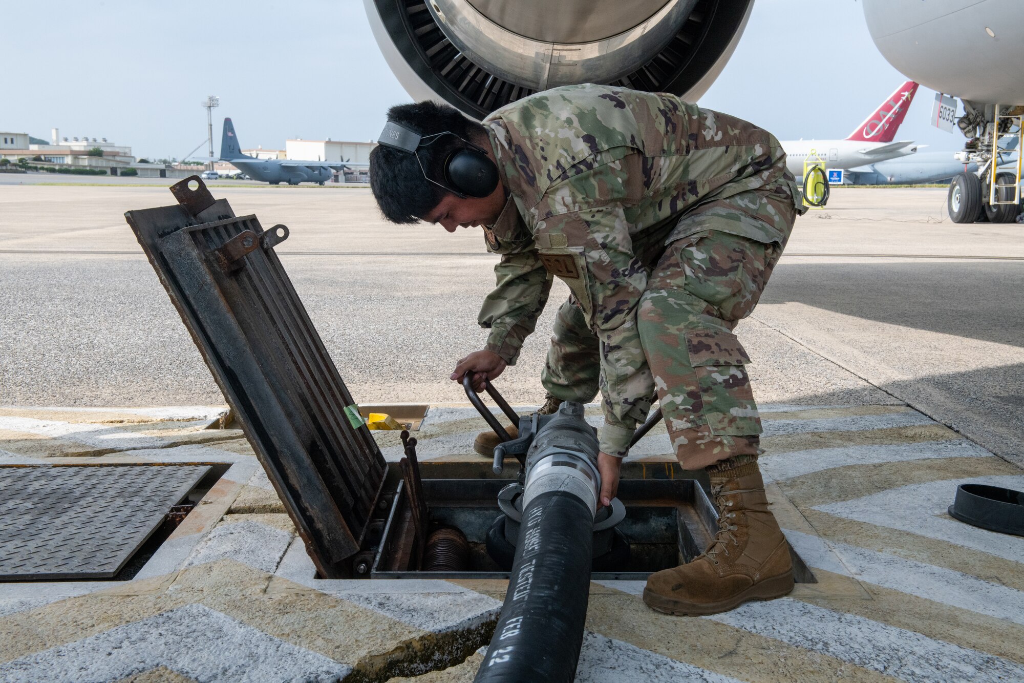 Airman 1st Class Israel Ortiz, 18th Logistics Readiness Squadron fuels distribution operator, connects a fuel hose to a fuel pit during a hot pit refueling mission Oct. 13, 2022, at Kadena Air Base, Japan.