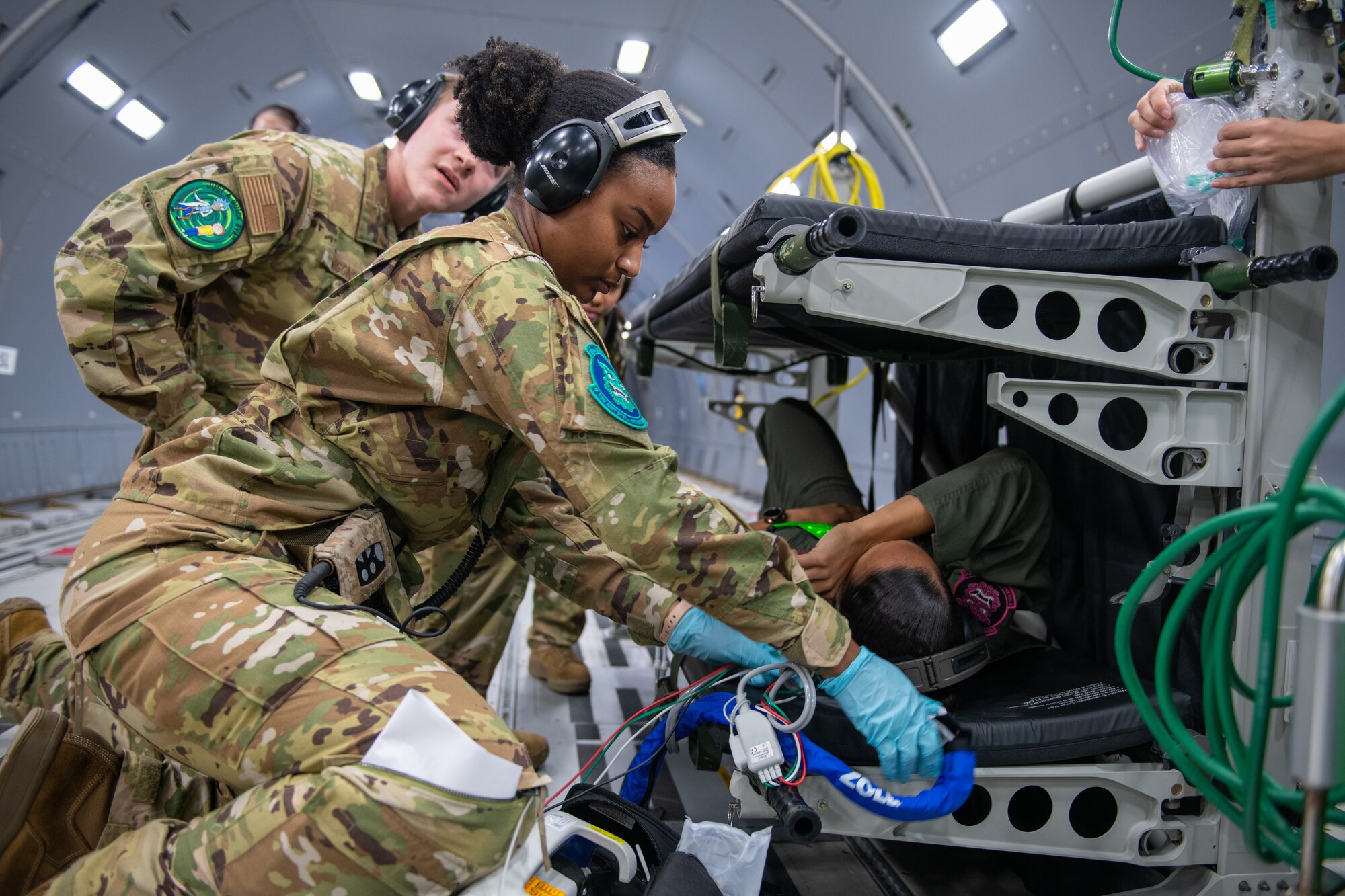 Staff Sgt. Jaylin Henderson, 18th Aeromedical Evacuation Squadron charge medical technician, collects a set of vitals from Master Sgt. Rihanna Scott, 18th AES aeromedical evacuation technician, during a simulated medical evacuation Oct. 14, 2022, based out of Kadena Air Base, Japan.