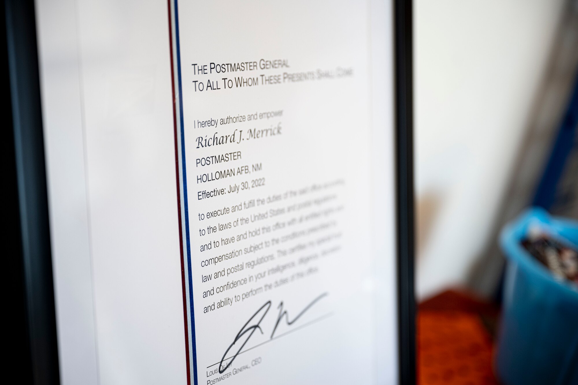 The official order declaring Richard Merrick the new Holloman Air Force Base post office postmaster, rests on a table during a swearing-in ceremony at Holloman Air Force Base, New Mexico, Oct. 19, 2022. The ceremony officially recognized Merrick, who has been on the job since June 2022, as the Holloman postmaster . (U.S. Air Force photo by Airman 1st Class Antonio Salfran)