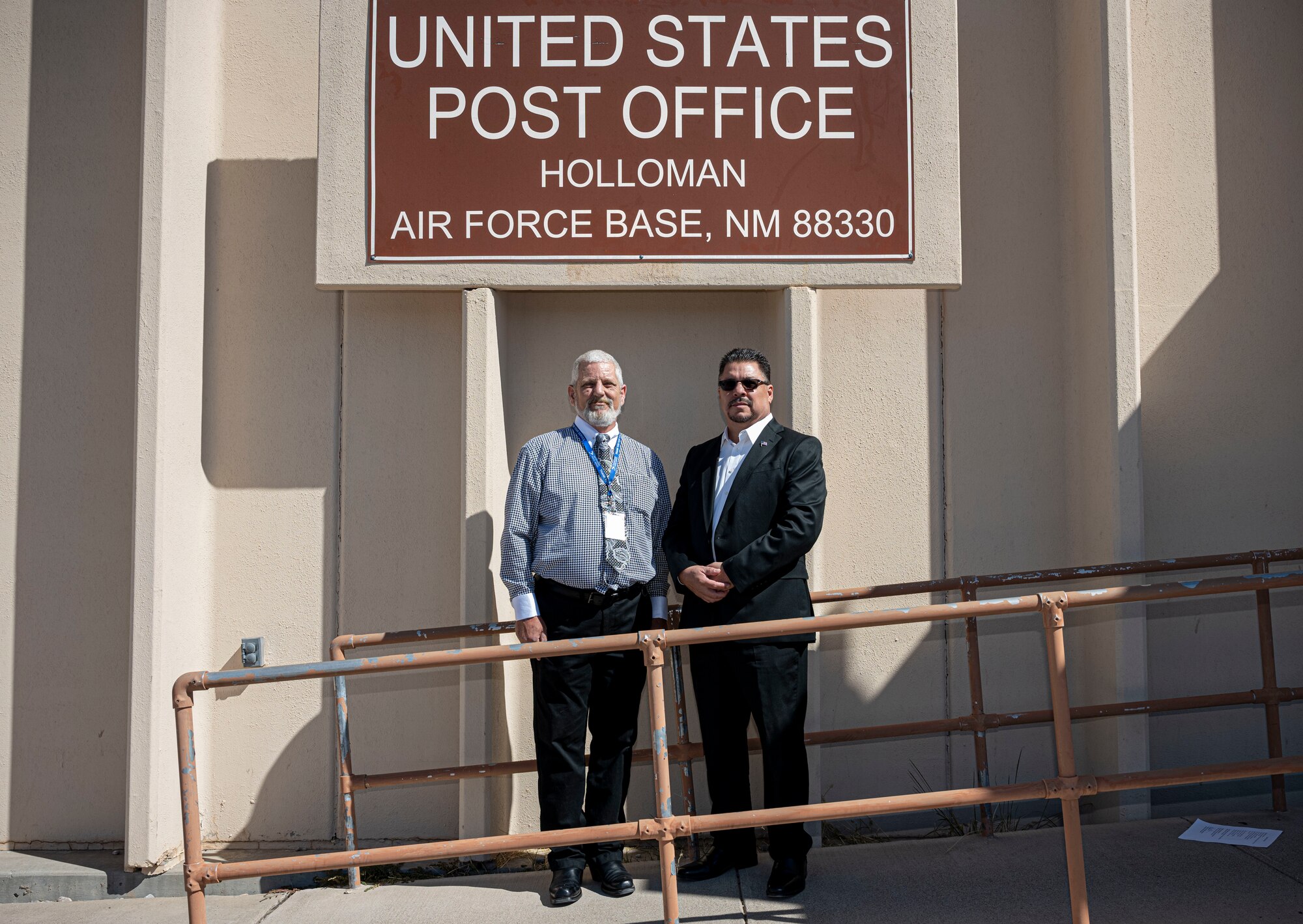 Richard Merrick, Holloman Air Force Base post office postmaster, left, and Paul Pantoja, U.S. Postal Service post office operations manager, pose for a picture during a swearing-in ceremony at Holloman Air Force Base, New Mexico, Oct. 19, 2022.  Merrick served in the U.S. Army and was stationed at Holloman in 1988 with the Army Air Operations Directorate beginning his 18-year career with the USPS. (U.S. Air Force photo by Airman 1st Class Antonio Salfran)