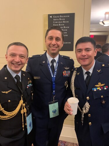 Three Airmen pose for a photo at the International Air Chiefs Conference.