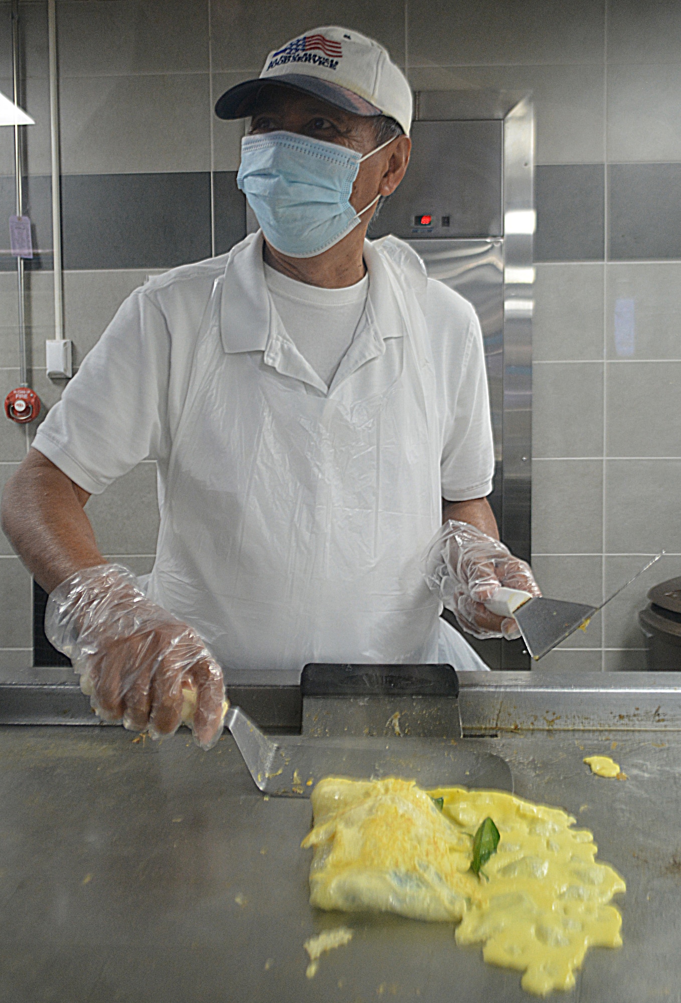 Julian Dancel, Freedom Hall Dining Facility cook, grills an omelet for an Airman during breakfast service at the Freedom Hall Dining Facility at Joint Base Andrews, Md., Oct. 4, 2022.