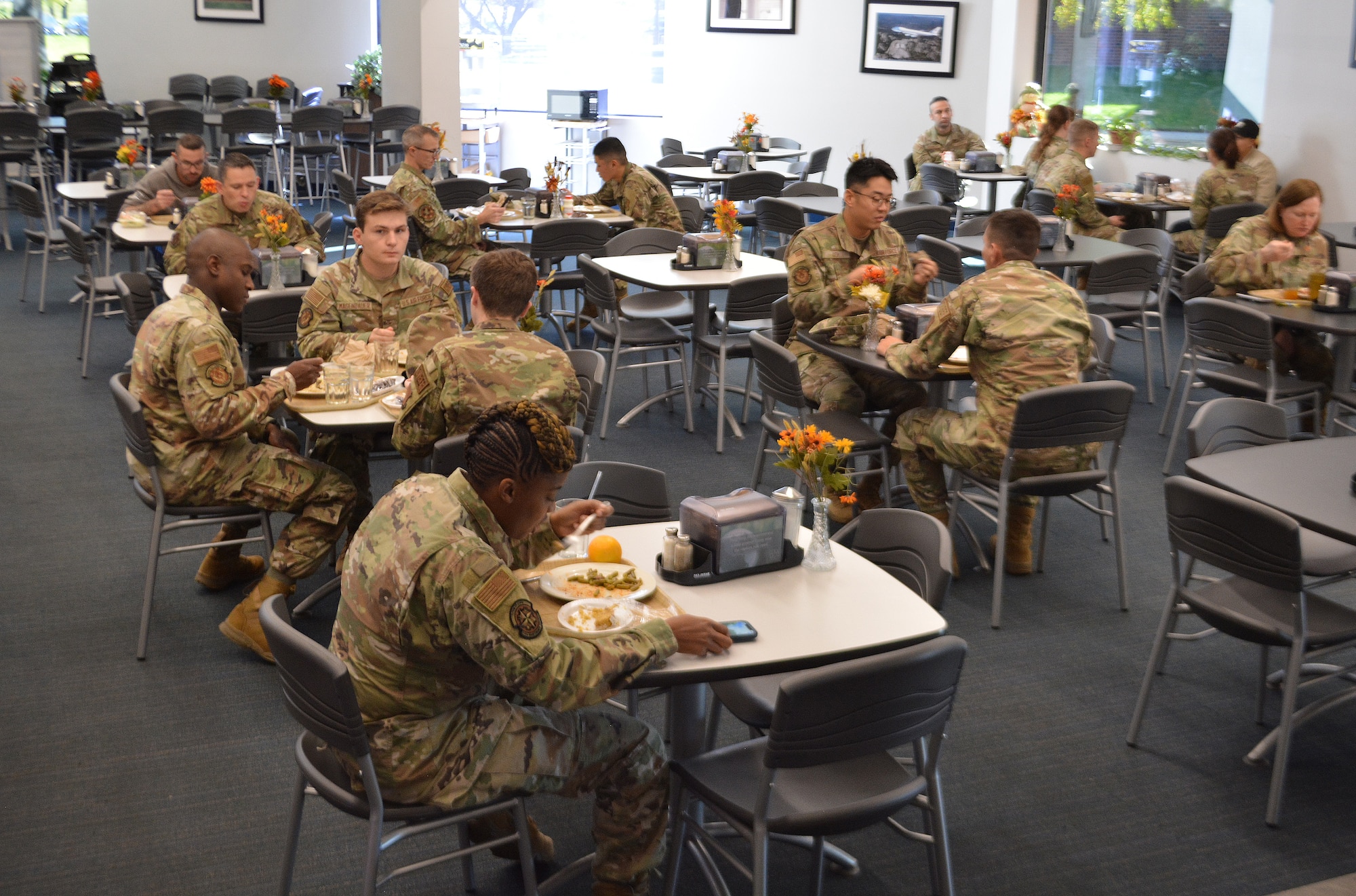 Airmen sit down for lunch at the Freedom Hall Dining Facility at Joint Base Andrews, Md., Oct. 11, 2022.