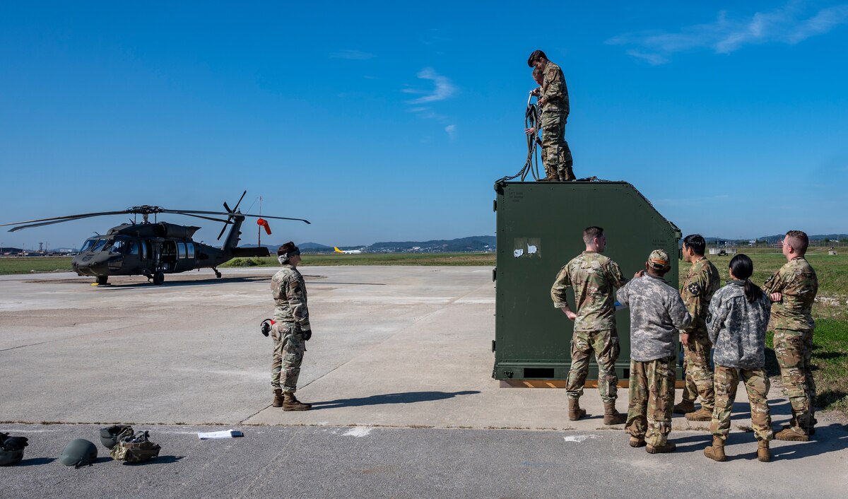 U.S. Air Force 51st Maintenance Group maintainers practice how to properly secure an Internal Slingable Unit during an integrated sling load training at Osan Air Base, Republic of Korea, Oct. 13, 2022.