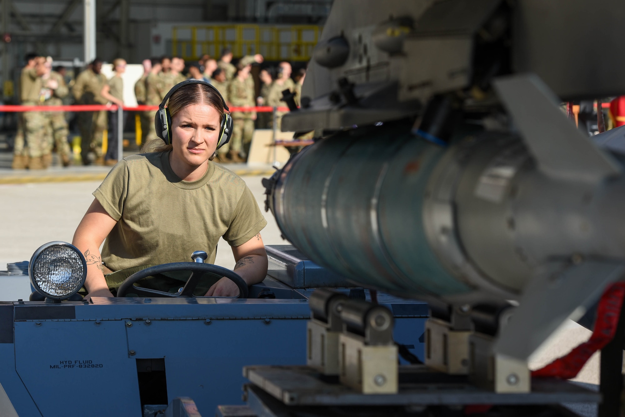 Airman 1st Class Summer Harrison, 555th Fighter Generation Squadron weapons load crew member, loads an inert munition onto an F-16 Fighting Falcon during the 3rd quarter Rapid Aircraft Generation and Employment (RAGE) event at Aviano Air Base, Italy, Oct. 14, 2022. RAGE competitions test weapons and munitions Airmen on technical proficiency, safety procedures and overall completion time. (U.S. Air Force photo by Senior Airman Brooke Moeder)