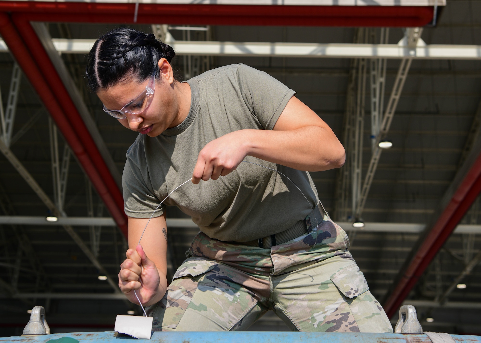 Senior Airman Korina Jimenez, 31st Munitions Squadron munitions controller, assembles an inert munition during the 3rd quarter Rapid Aircraft Generation and Employment (RAGE) event at Aviano Air Base, Italy, Oct. 14, 2022. RAGE showcases Aviano’s lethal combat capabilities and prove Agile Combat Employment (ACE) effectiveness through demonstrations and competitions. (U.S. Air Force photo by Senior Airman Brooke Moeder)