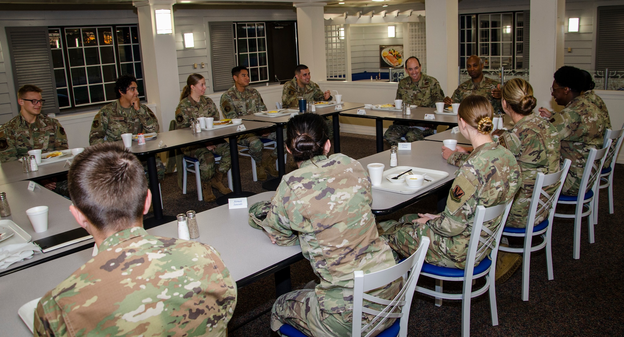 Folks sit at tables talking.