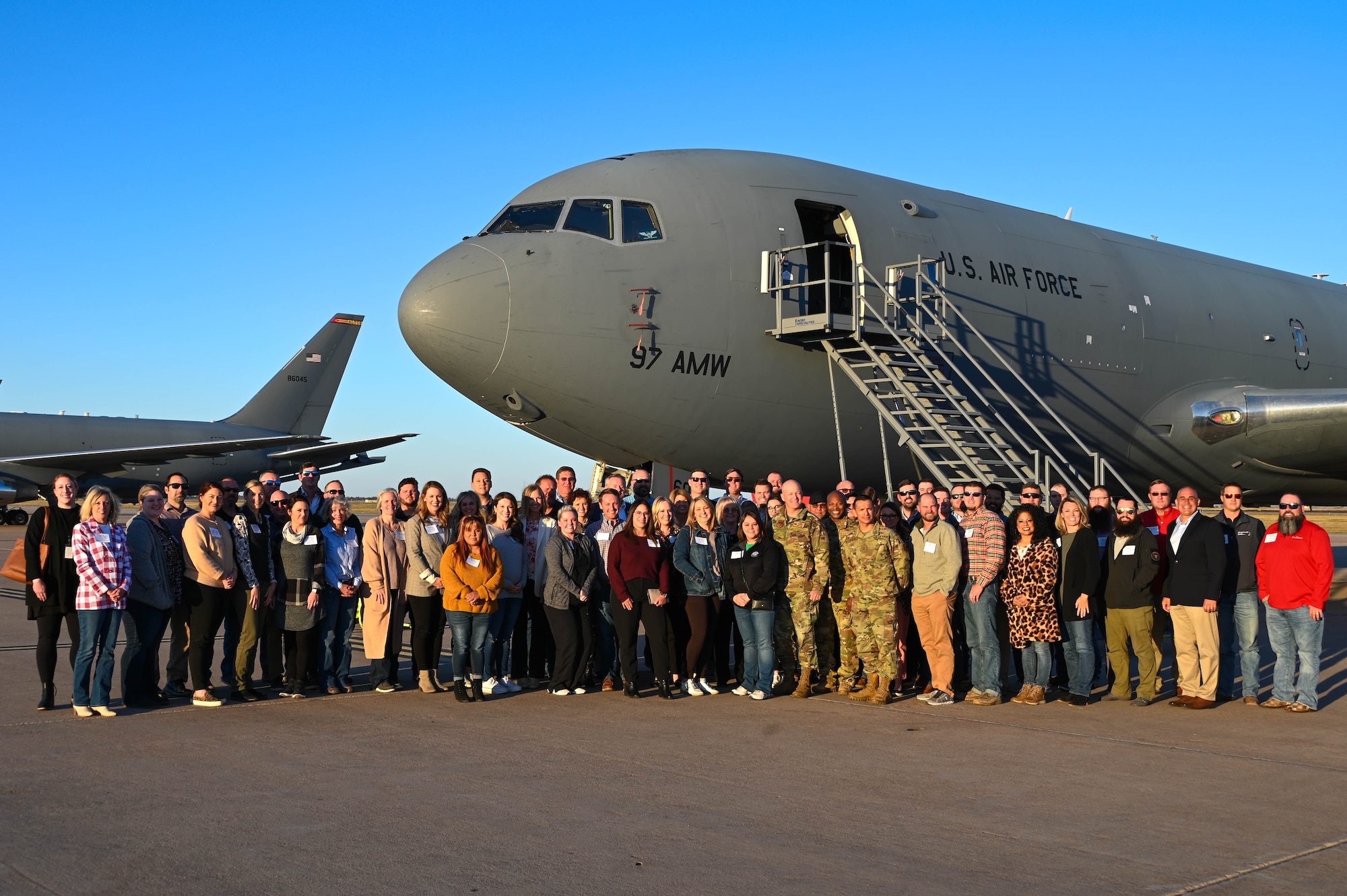 Community members from the local area pose for a group photo outside a KC-46 Pegasus at Altus Air Force Base, Oklahoma, Oct. 18, 2022. More than 60 community members attended the tour. (U.S. Air Force photo by Senior Airman Trenton Jancze)