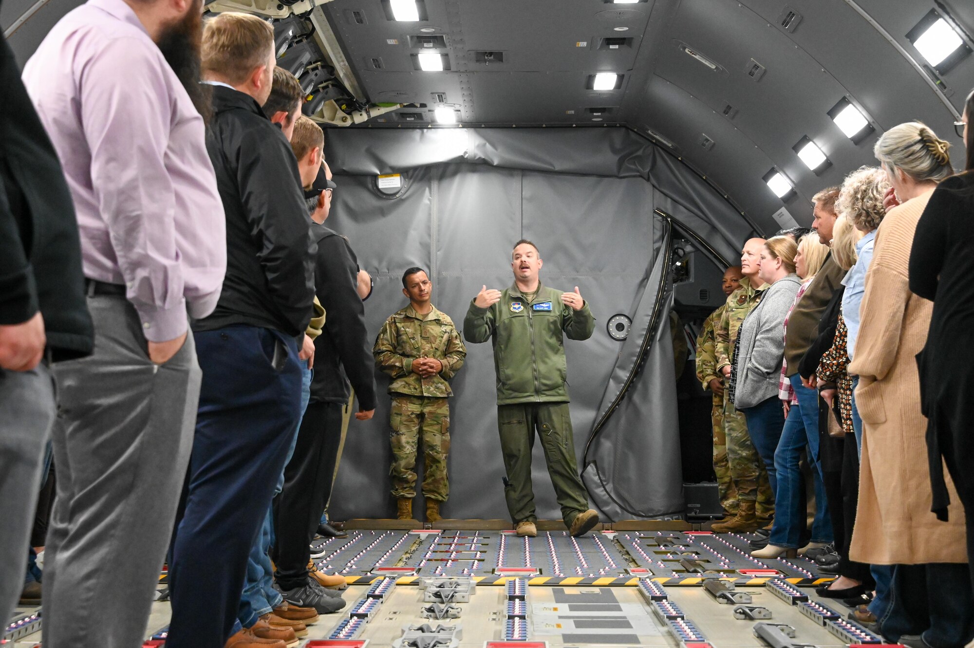U.S. Air Force Maj. Gary Sowa, 56th Air Refueling Squadron instructor pilot, talks to community members while on a KC-46 Pegasus at Altus Air Force Base, Oklahoma, Oct. 18, 2022. Sowa provided information about the KC-46 cargo capabilities. (U.S. Air Force photo by Senior Airman Trenton Jancze)