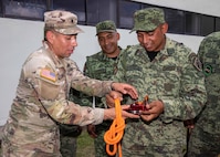 U.S. Army Spc. Francisco Ovalle, assigned to the 92nd Engineer Battalion, 526th Engineer Construction Company, based out of Fort Stewart, Ga., familiarizes himself with Mexican army search-and-rescue equipment alongside Mexican army Subteniente (Lieutenant) Eduardo Bobadilla, assigned to the 19th Motorized Cavalry, during exercise Fuerzas Amigas 2022 on Campo Militar Reynosa, Mexico, Oct. 17, 2022.