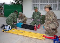 U.S. Soldiers and Mexican army personnel work together to treat a simulated casualty during exercise Fuerzas Amigas 2022 at Campo Militar Reynosa, Mexico, Oct. 18, 2022.
