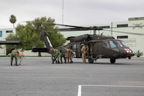 U.S. Soldiers assigned to the 520th Area Support Medical Company, 56th Multifunctional Medical Battalion, 62nd Medical Brigade and Mexican army personnel assigned the 19th Motorized Cavalry Regiment transport a simulated casualty from an HH-60M Blackhawk helicopter attached to the 2nd General Support Aviation Battalion, 3rd Combat Aviation Brigade, 3rd Infantry Division, from Hunter Army Airfield, Ga., Regiment during medical evacuation training as part of exercise Fuerzas Amigas 2022 at Campo Militar Reynosa, Mexico, Oct. 18, 2022.