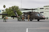 U.S. Soldiers assigned to the 520th Area Support Medical Company, 56th Multifunctional Medical Battalion, 62nd Medical Brigade and Mexican army personnel assigned the 19th Motorized Cavalry Regiment transport a simulated casualty from an HH-60M Blackhawk helicopter attached to the 2nd General Support Aviation Battalion, 3rd Combat Aviation Brigade, 3rd Infantry Division, from Hunter Army Airfield, Ga., Regiment during medical evacuation training as part of exercise Fuerzas Amigas 2022 at Campo Militar Reynosa, Mexico, Oct. 18, 2022.