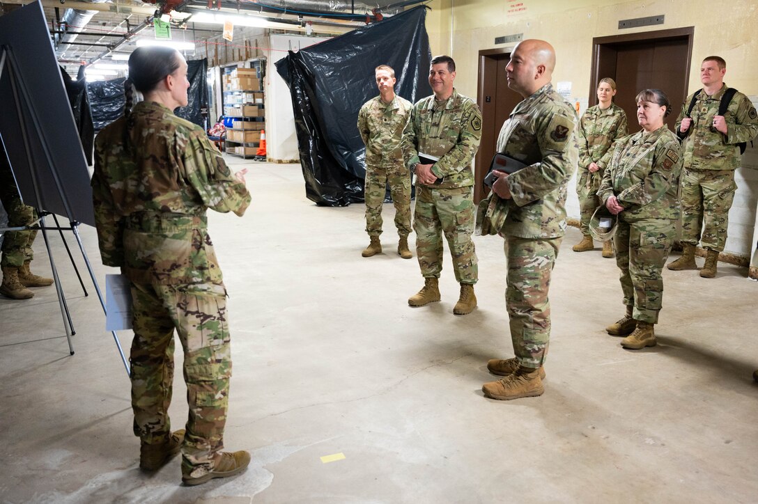 Maj. Gen. Andrew Gebara, center, 8th Air Force and Joint-Global Strike Operations Center commander, and Chief Master Sgt. Steve Cenov, 8th Air Force command chief and J-GSOC senior enlisted leader, are briefed by a member of the 28th Bomb Wing at Ellsworth Air Force Base, S.D., Oct. 17, 2022. Members of Ellsworth showcased significant contributions to the long-range strike mission and how they continue to maintain readiness and innovate.(U.S. Air Force photo by Staff Sgt. Alexi Bosarge)