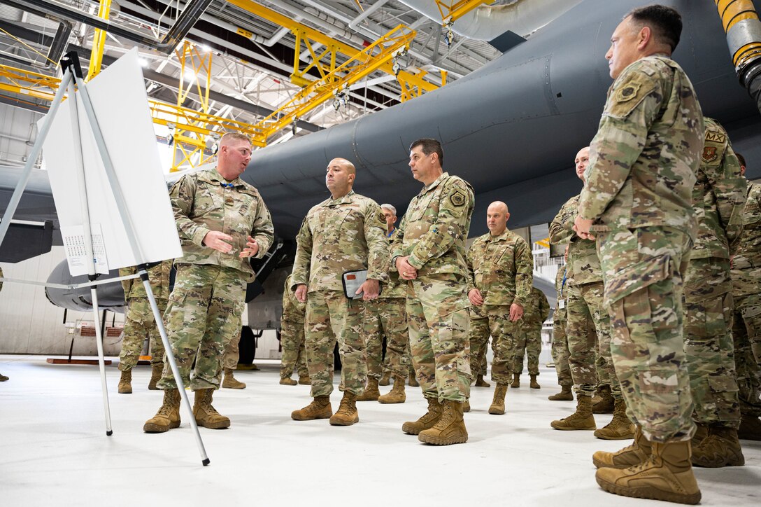 Maj. Gen. Andrew Gebara, 8th Air Force and Joint-Global Strike Operations Center commander, and Chief Master Sgt. Steve Cenov, 8th Air Force command chief and J-GSOC senior enlisted leader, are briefed by a member of the 28th Bomb Wing at Ellsworth Air Force Base, S.D., Oct. 17, 2022. During the visit, 8th Air Force leaders spoke with Airmen across the 28th Bomb Wing to better understand their needs as Ellsworth prepares for and takes on the B-21 Raider mission. (U.S. Air Force photo by Staff Sgt. Alexi Bosarge)