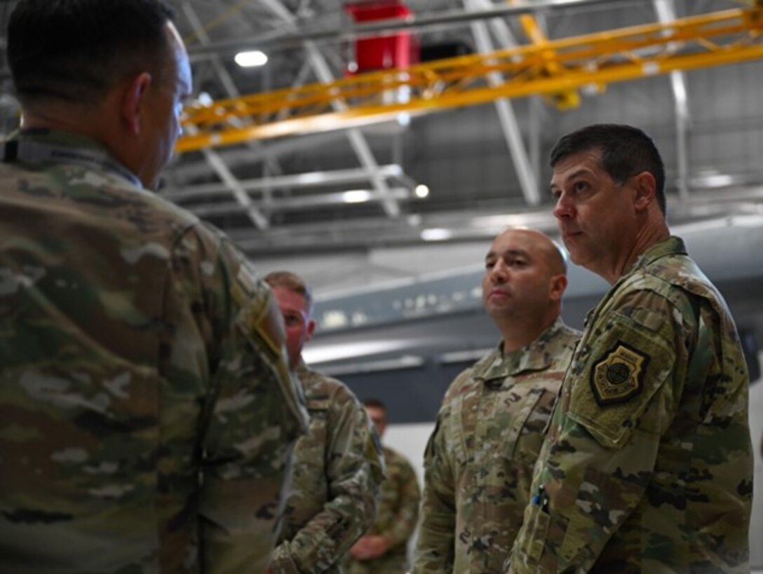 Maj. Gen. Andrew Gebara, right, 8th Air Force and Joint-Global Strike Operations Center commander, and Chief Master Sgt. Steve Cenov, 8th Air Force command chief and J-GSOC senior enlisted leader, are briefed by a member of the 28th Bomb Wing at Ellsworth Air Force Base, S.D., Oct. 17, 2022. Members of Ellsworth showcased significant contributions to the long-range strike mission and how they continue to maintain readiness and innovate. (U.S. Air Force Photo by Airman Yendi Borjas)