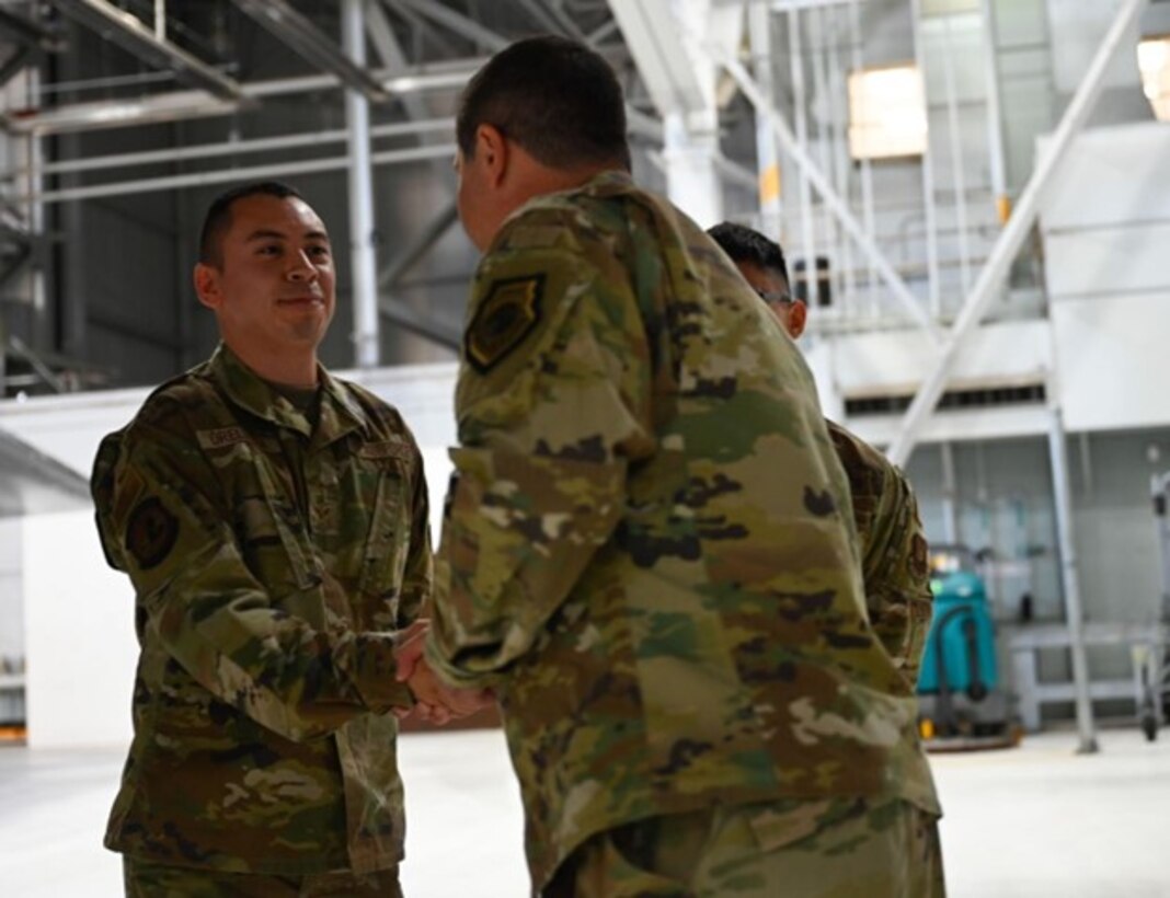 Senior Airman Everardo Orellana, assigned to the 28th Bomb Wing, receives a coin from Maj. Gen. Andrew Gebara, 8th Air Force and Joint-Global Strike Operations Center commander, at Ellsworth Air Force Base, S.D. Oct. 17, 2022. Coining’s are traditionally used to reward and recognize service members for their exceptional work inside and outside of the workplace. (U.S. Air Force Photo by Airman Yendi Borjas)
