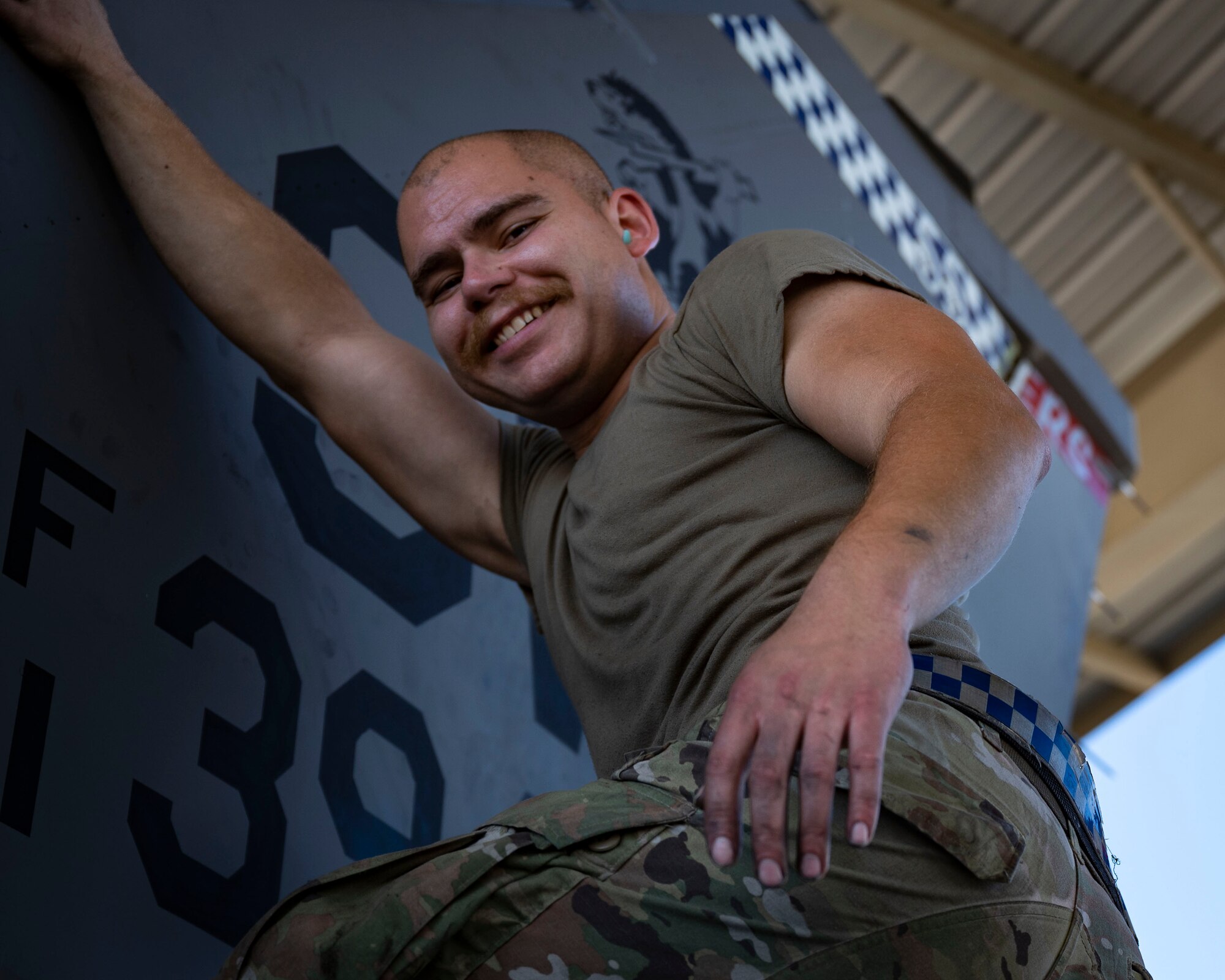 Airman stands on a F-16