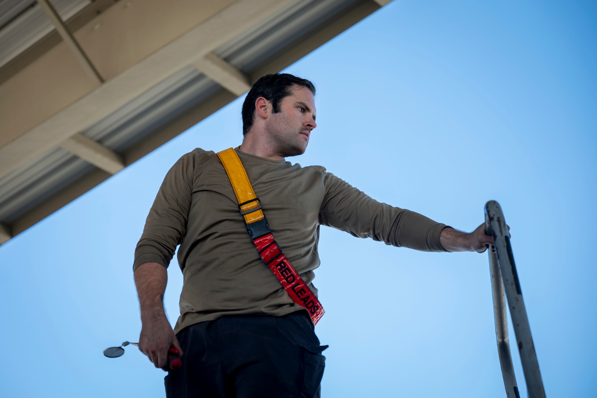 Airman stands on a ladder