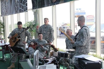 Roger Kirchner (center) and band mates talk during a break from playing.