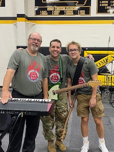 Roger Kirchner (center), poses with his father Keith (left), and his son Royal (right), at Van Buren High School. This is the school where Keith was a teacher and Roger a student.