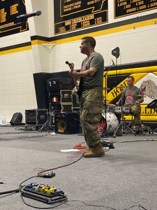 Roger Kirchner plays guitar during a performance of "Fire for Effect," the rock band that is a part of the 135th Army Band.