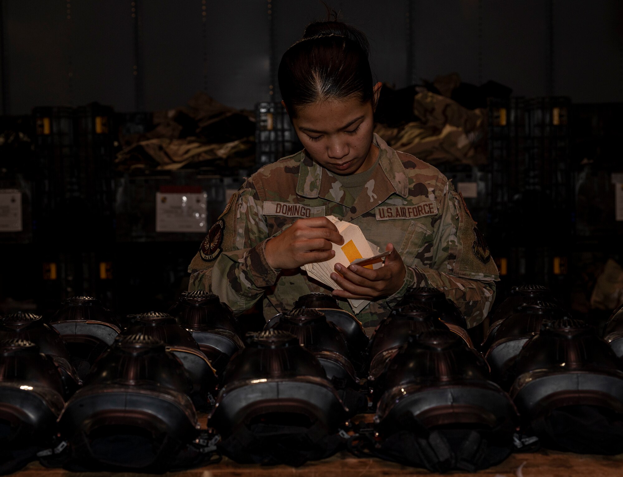 Airman 1st Class Lyka Domingo, 4th Logistics Readiness Squadron supply technician, labels an M-50 joint service general purpose masks for inventory, at Seymour Johnson Air Force Base, North Carolina, Oct. 20, 2022. Members of the 4th LRS supply shop are responsible for operating supply systems and activities in order to provide necessary equipment and supplies for base operations. (U.S. Air Force photo by Airman 1st Class Sabrina Fuller)