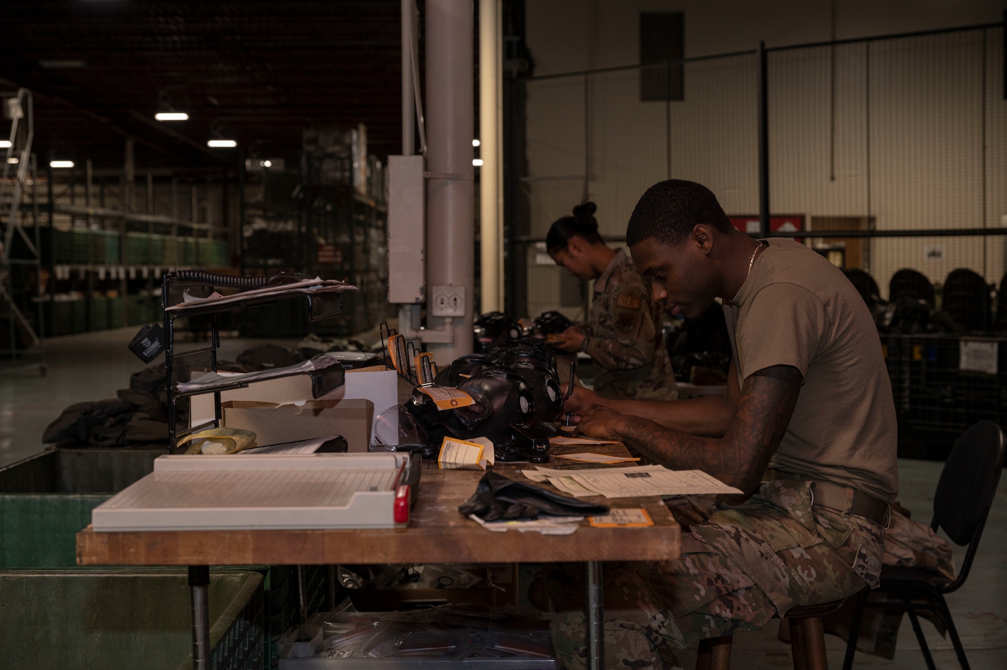 Airman 1st Class Lyka Domingo (left) and Airman Wayne West, both 4th Logistics Readiness Squadron supply technicians, ensure appropriate inventory of M-50 joint service general purpose masks, at Seymour Johnson Air Force Base, North Carolina, Oct. 20, 2022. The 4th LRS supply shop manages, organizes and secures military assets to keep base personnel operational. (U.S. Air Force photo by Airman 1st Class Sabrina Fuller)
