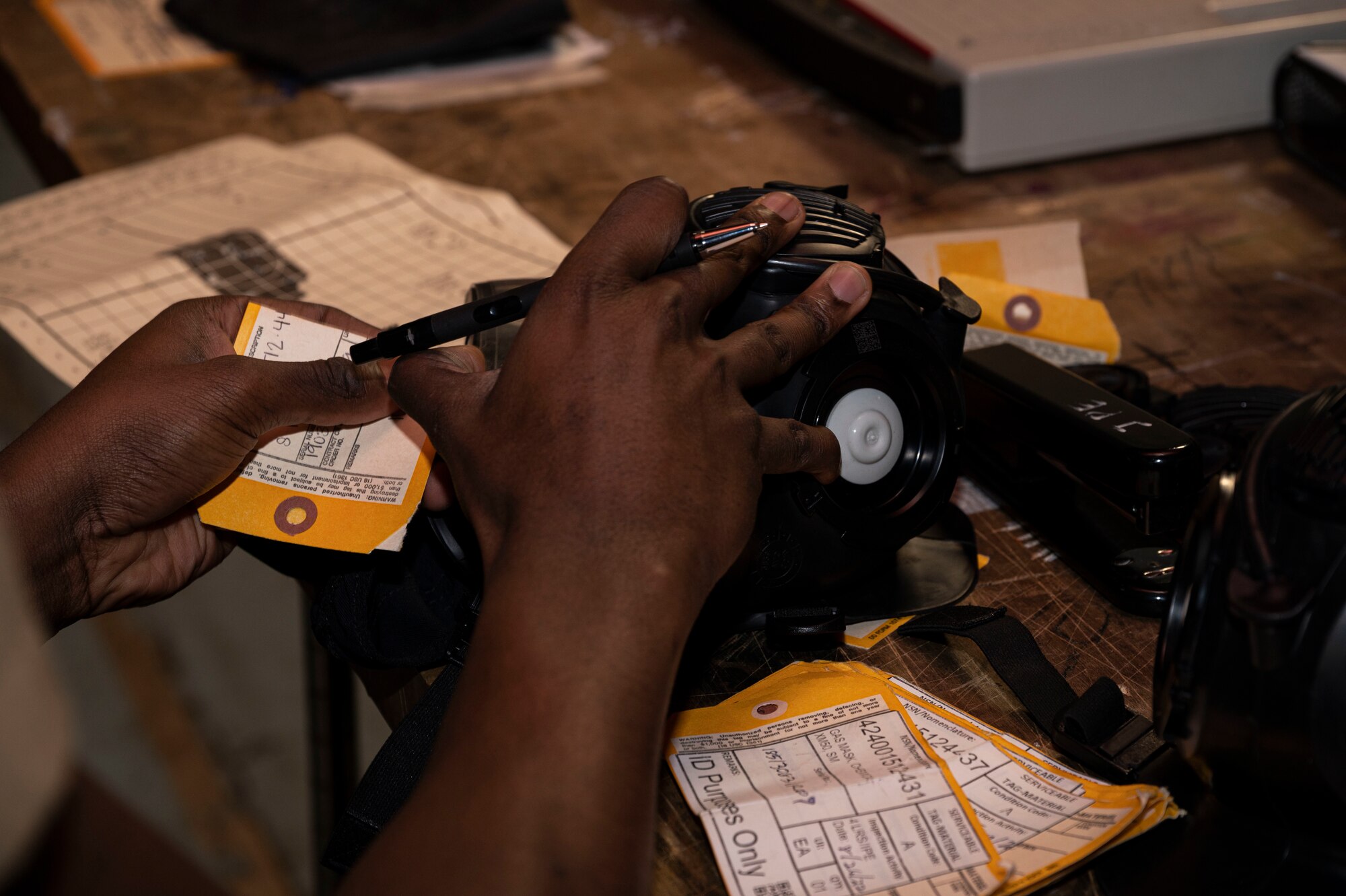 Airman Wayne West, 4th Logistics Readiness Squadron supply technician, inserts a label into an M-50 joint service general purpose mask, at Seymour Johnson Air Force Base, North Carolina, Oct. 20, 2022. Supply technicians perform limited aspects of technical supply management work, including inventory management, cataloging and property utilization. (U.S. Air Force photo by Airman 1st Class Sabrina Fuller)