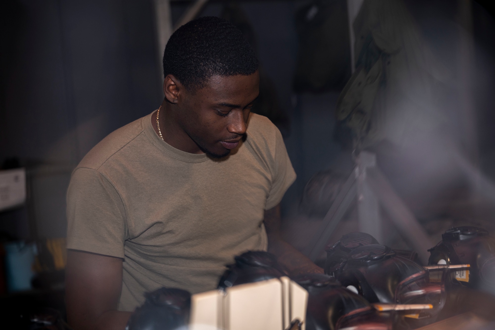 Airman Wayne West, 4th Logistics Readiness Squadron supply technician, inspects M-50 joint service general purpose masks at Seymour Johnson Air Force Base, North Carolina, Oct. 20, 2022. The 4th LRS supply shop manages, organizes and secures military assets to keep base personnel operational. (U.S. Air Force photo by Airman 1st Class Sabrina Fuller)