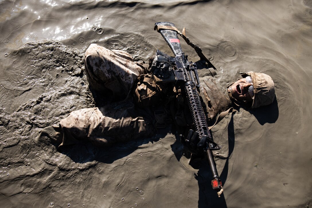 U.S. Marine Corps recruit with Delta Company, 1st Recruit Training Battalion, back crawls during the Crucible at Camp Pendleton, California, Oct. 17, 2022. The Crucible is a 54-hour culminating event consisting of mentally and physically demanding challenges with limited food and sleep. (U.S. Marine Corps photo by Cpl. Pio)