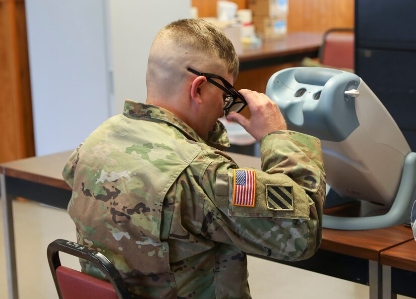 A Soldier undergoes a visual test Oct. 19, 2022, at Fort Indiantown Gap, Pa., as part of the Technician Occupational Medical Surveillance Program. Federal technicians in the Pennsylvania National Guard who are exposed or potentially exposed to occupational hazards are enrolled in the program and evaluated annually in their birth month.