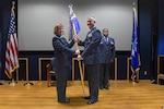 Col. Jeanne Bisesi, 433rd Mission Support Group commander, presents the guidon to Maj. Mark Howard, 433rd Security Forces Squadron commander, during the 433rd SFS assumption of command ceremony at Joint Base San Antonio-Lackland, Texas, Oct. 15, 2022. The assumption of command ceremony marks a formal passing of responsibility, authority and accountability of command. (U.S. Air Force photo by Staff Sgt. Adriana Barrientos)