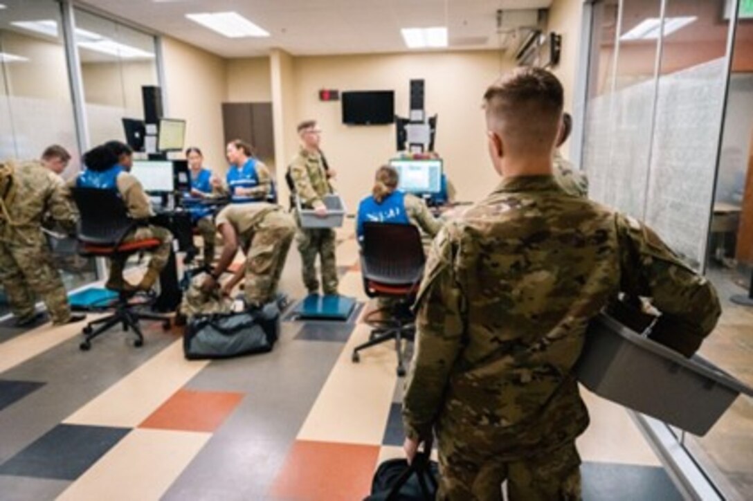 U.S. Airmen assigned to the 28th Bomb Wing go through the installation deployment readiness center in preparation for a Bomber Task Force operation at Ellsworth Air Force Base, South Dakota, on Oct. 14, 2022. The United States maintains a strong, credible bomber force that enhances the security and stability of Allies and partners. (U.S. Air Force photo by Senior Airman Austin McIntosh)