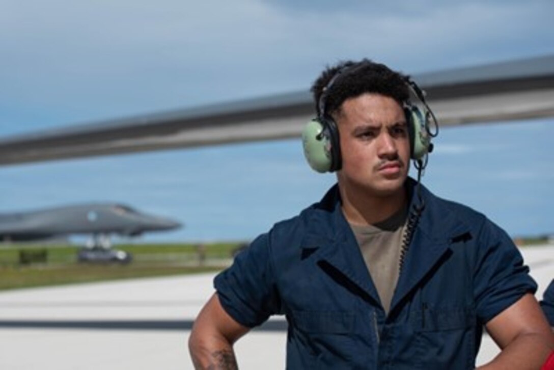 U.S. Air Force Senior Airman Christopher Cline, 28th Aircraft Maintenance Squadron crew chief assigned to Ellsworth Air Force Base, South Dakota, oversees aircraft recovery operations at Andersen Air Force Base, Guam, Oct. 18, 2022. These missions enhance readiness, to include joint and multi-lateral, to respond to any potential crisis or challenge in the Indo-Pacific. (U.S. Air Force photo by Senior Airman Yosselin Campos)