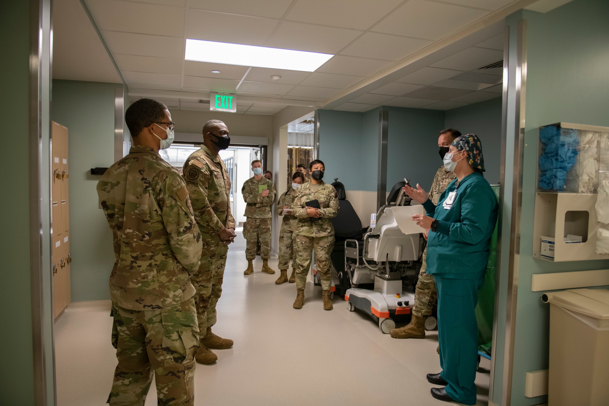 A group of Airmen surround U.S. Air Force Maj. Jennifer Terrebonne, right, while she gives a brief at David Grant USAF Medical Center, Travis Air Force Base, California, Oct. 12, 2022.