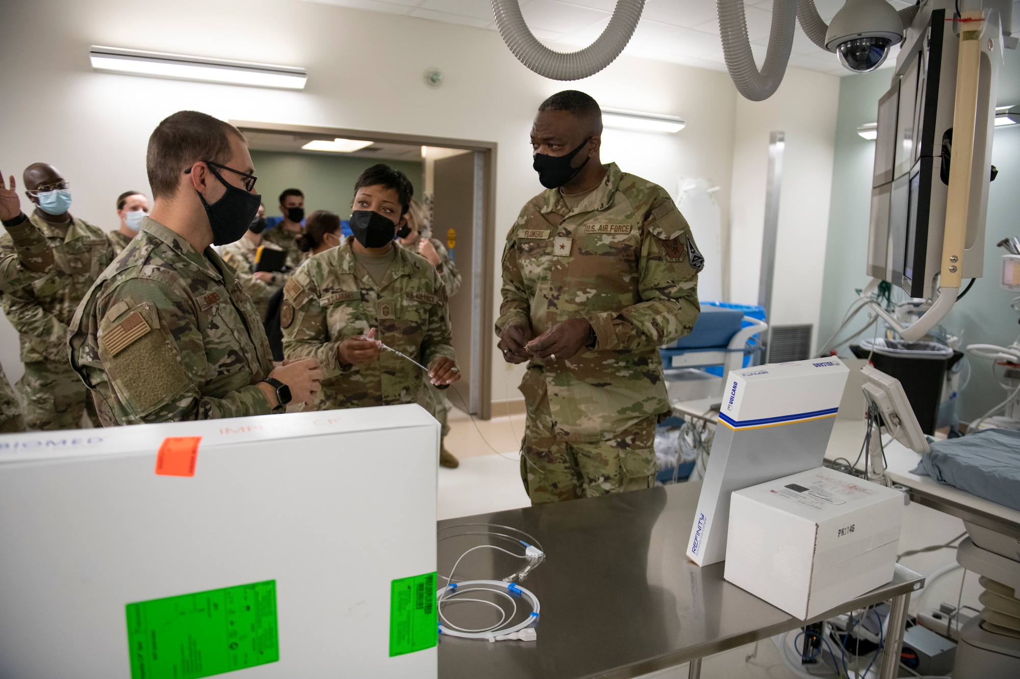 An Airman demonstrates cardiac catheterization equipment to Brig. Gen. Alfred K. Flowers, Jr., and Chief Master Sgt. Kenya E. Williams, at David Grant USAF Medical Center, Travis Air Force Base, California, Oct. 12, 2022.