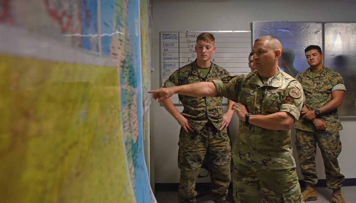 U.S. Air Force Master Sgt. Anthony Madrid, 316th Training Squadron flight chief for the signals intelligence flight, corrects a student’s brief during the capstone exercise, Operation Loneshark, at Goodfellow Air Force Base, Texas, Oct. 11, 2022. Madrid explained that if an airplane was lost, it is the intelligence professional’s job to pinpoint its last known location and determine if any threats caused the downing of the aircraft. (U.S. Air Force photo by Senior Airman Abbey Rieves)